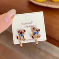Cute cartoon puppy earrings in khaki enamel with blue scarf on a display card - Puffy Eyed Dog (KTW54)