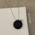 Retro wooden perfume bottle pendant necklace with silver chain on beige leather bag - Black Round Necklace