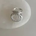 Detailed macro shot of silver open ring featuring oval hollow design with pearl inlay - Geometric Pearl Ring
