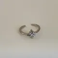 Nahaufnahme eines Vintage-Silberrings mit Sternblumen-Motiv und glänzenden Zirkonia - Kreuz-Blumen-Vierzirkonia-Offen-Stil (Kuan 10 Ring)