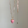 Detalle del collar con colgante de fresa rosa con cadena dorada y cinta tejida - Estilo 6 Collar de Fresa con Cinta