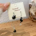 Asymmetric black cat earrings with velvet stars and moon elements on jewelry card - Star Black Cat Earrings (MMW18)
