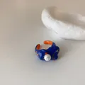 Close-up of artistic irregular open ring with blue orange enamel and pearl detail - Blue (Orange Splicing/Faux Pearl)