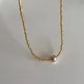Detailed macro of gold twisted metal beads and a pale pink pearl on a vintage necklace - Gold Necklace (Gold Plated)