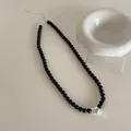 Close-up of black beaded necklace with a silver heart pendant and adjustable clasp - Small Heart Style