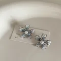 Detailed view of flower earrings with blue gradient crystal petals and center pearl - Pearl Crystal Flower Style