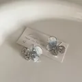 Detailed shot of blue crystal butterfly earrings with silver hollow wing design - Zircon Crystal Butterfly Style