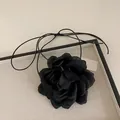 Detailed view of handmade black lace flower choker with elegant fabric petals and long ties - Large Black Flower Necklace