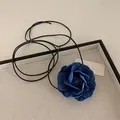 Detail of blue denim rose necklace showing layered petals with frayed edges and long cords - Deep Blue Flower Necklace