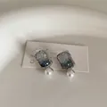 Detail of blue gradient crystal rectangle earrings with a single white round pearl drop - Square Crystal Style