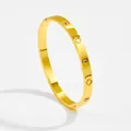 Detailed view of gold bangle featuring alternating zircon stones and clover patterns - Gold Hollow Four-leaf Clover Inlaid Style (4154)