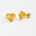 Macro detail of gold heart earrings with sunburst texture and secure screw-back closure - Heart