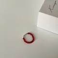 Close-up of red agate beaded elastic ring with silver metal tube on white background - Red Agate Real Gold Plated