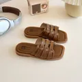 Brown woven flat slides for girls with cross-strap design and soft leather sole - EU 26 / Brown
