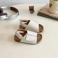 Beige open-toe girls' sandals with cork texture sole and velcro straps in a cozy setting - EU 21 / White