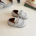 Girls minimalist light grey suede loafers with bow detail in a cozy lifestyle setting - 21 / Beige