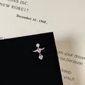 Macro detail of silver winged pink heart stud earring with zircon on a velvet stand - Exquisite Winged Heart Style (5506020064616)