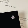 Close-up of a butterfly screw back earring with pink zircon on black velvet display - Butterfly Pendant Style (5506020064622)