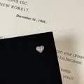 Macro shot of silver heart stud earring with pink zircon and claw setting on a book - Four-prong Pink Heart Gem Style (5506020064633)