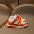 Children's casual skate shoes featuring bright orange and white leather color blocking - EU 31 / Orange