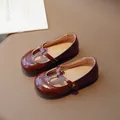 Dark brown patent leather Mary Jane shoes for girls with criss-cross straps and shiny finish - EU 21 / Dark Brown