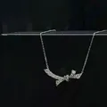 Detailed view of silver bow necklace with pavé cubic zirconia on black jewelry box - Bowknot Necklace
