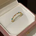 Close-up of gold flower ring with blue and pink stones in a pink velvet jewelry box - Colorful Zircon Style (Gold Plated)
