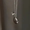 Macro detail of silver fluid metal waterdrop pendant with a high-shine mirror finish - Water Bottle Style (Real Gold Plated)