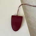 Detailed view of handmade burgundy leather clochette holder with refined edge stitching - Shield Neck Hanging Style / Ankora Red Leather