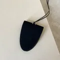 Macro shot of minimalist black suede clochette key case with meticulous stitching - Shield Neck Hanging Style / Black Suede