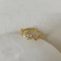 Macro detail of golden open ring featuring purple enamel butterfly and zircon inlays - Purple Enamel Bow Style (Style 6 Ring)