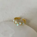 Detail of light blue enamel flowers and sparkling zircons on an adjustable gold-plated ring - Light Blue Flower Zirconia Ring (Style 7)