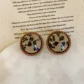 Close-up of vintage leopard print resin stud earrings with twisted brown border detail - 925 Silver Earring Post / Style 2 Round Leopard Twist Frame