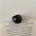 Macro detail of glossy black resin chunky ring on vintage aesthetic fabric backdrop - Ring (3097)