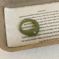 Macro shot of green translucent resin ring with polished finish on rustic burlap - Green Ring