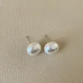 Close-up of French vintage irregular hammer texture pearl earrings with silver posts - Hemispherical Pearl / Large (14mm)