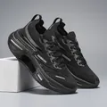Black cushioned running shoes with breathable flyknit mesh and retro lettering detail - EU 36 / Black