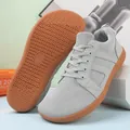 Detail view of breathable grey knit mesh fabric and non-slip rubber outsole on sports shoes - 36 / Gray