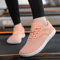 Detail of breathable orange mesh sneakers with white sole shown on a treadmill - 36 / Pink