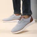 Close-up of gray breathable knit loafer with brown leather accents and white non-slip sole - EU 40 / Gray