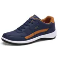 Men's navy blue leather sneakers with brown trim and waterproof detail, side view - 38 / 8001 Deep Blue