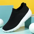 Lightweight black mesh slip-on shoe with white cushioned sole on stylish background - EU 36 / Black and White
