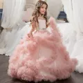 Detail of multi-layered pink tulle skirt with ruffled layers and a rhinestone flower belt - Pink / 8-9 Years