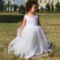 Close-up of white flower girl dress featuring intricate lace embroidery and tiered tulle hem - 8-9 Years / Beige