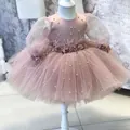 Detailed close-up of beaded pearls and feather flower on pink mesh princess dress - 100 / Dusty Pink