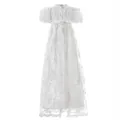 Detailed view of white floral lace fabric and delicate ribbon bows on the christening gown - 6m / White