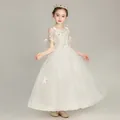Detailed view of the white floral embroidery and delicate mesh lace on girls gown - White Long Dress Style / 110cm