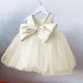 Close-up of champagne flower girl dress with pearl neckline and large satin back bow - 80cm / Champagne
