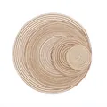 Macro view of woven round heat-resistant placemats in natural sisal and white cotton - Brown