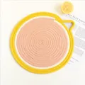 Detail of lemon slice woven cotton placemat featuring spiral rope stitching and a small loop - S / Grapefruit